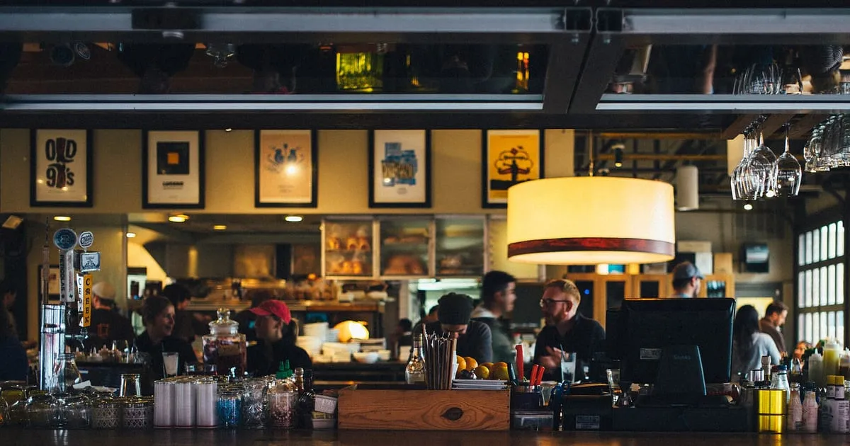 Staff at work behind the counter of a busy independent cafe and restaurant